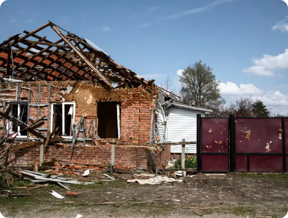 Home in Southern Florida with severe structural damage after a tropical storm. Damage restoration services in Tampa includes roof replacement, siding repair, replacing broken windows, and more.
