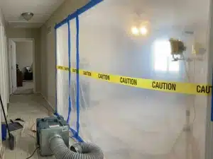 Mildew and mold remediation services in Tampa, Florida for a home that was vacant during the summer. Restoration experts use equipment to remove moisture from parts of the home with mold growth.